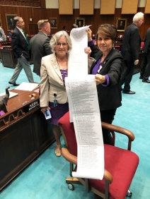 Minority Leader Charlene Fernandez and Rep. Pamela Powers Hannley hold a list of Arizona voters who supported ratification of the ERA on the Legislature's Request to Speak System.