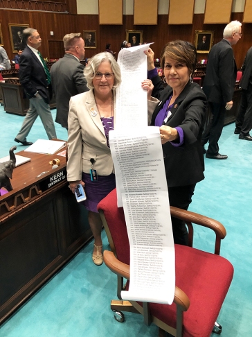 Minority Leader Charlene Fernandez and Rep. Pamela Powers Hannley hold a list of Arizona voters who supported ratification of the ERA on the Legislature's Request to Speak System.
